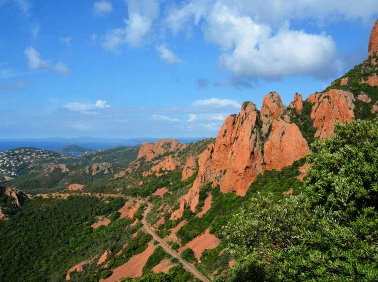 View of The Esterel massif and its red mountains which literally plunge into the Mediterranean Sea .   located between Saint-RaphaÃ«l and Mandelieu in South East of France on the french riviera  While the inland part of the Esterel plunges into the Var region. Listed natural park, the heart of the massif has remained untouched, with no  village. It's a natural Parc and there are many possibilities for hiking in the Esterel massif  . it was a sunny morning in June