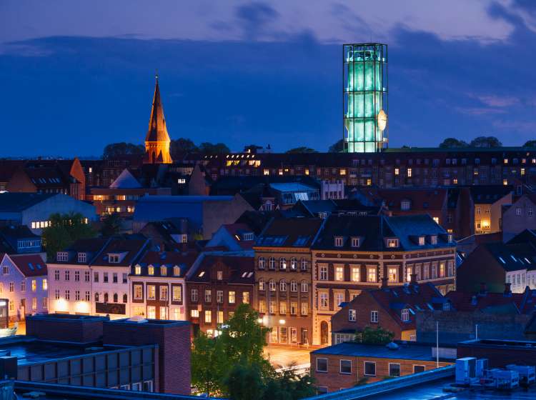 Denmark, Jutland, Aarhus, elevated city view with Aarhus Town Hall, designed in 1942 by Danish Archtect Arne Jacobsen, evening