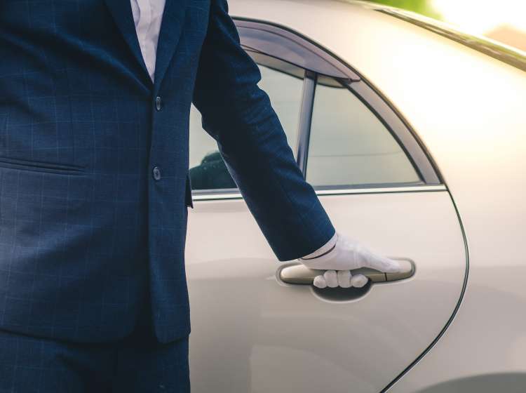 Closeup of Chauffeur opening car door with glove; Shutterstock ID 754381660; Invoice Number: -