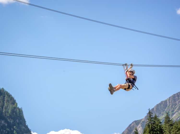 Teenager having fun on a zip line in the Alps, adventure, climbing, via ferrata during active vacations in summer; Shutterstock ID 1051170863; Invoice Number: -