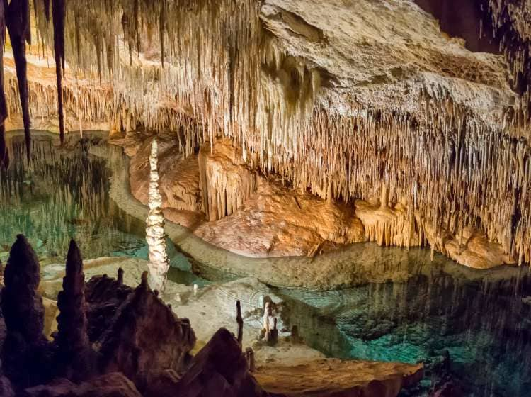 Inside a big limestone cave with an underground sea water lake. This is Cuevas del Drach in Mallorca, Spain.