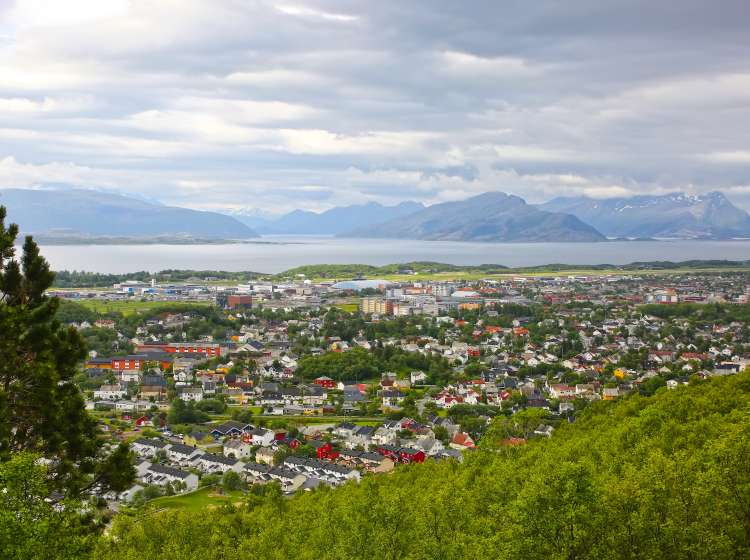 View over the cityscape of Bodo, Norway. Houses in the foreground & the sea & mountains in the background, Scandinavia. BodÃ¸ is a municipality in Nordland county, Norway. It is part of the traditional region of Salten.