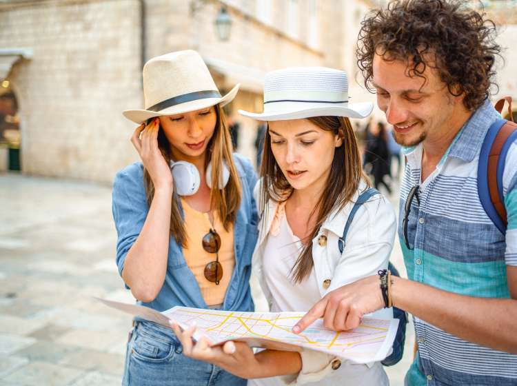 Curious tourists looking at a map of the city