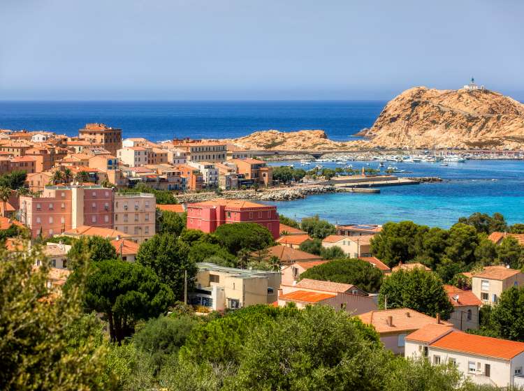 View of the city of L'Ile Rousse on Corsica, France, with the island Ile de la Pietra