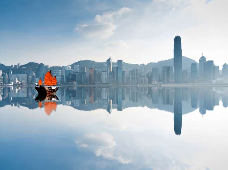 Junk boat crossing Hong Kong harbor.