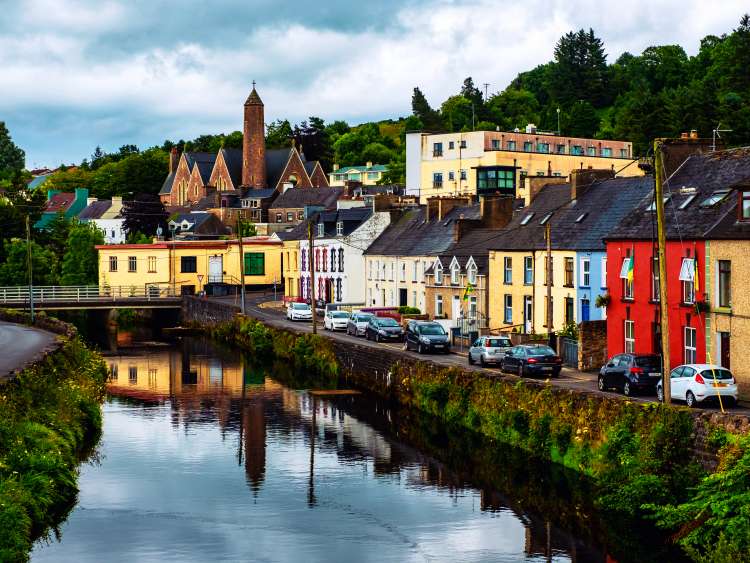 Donegal, Ireland. Beautiful landscape in Donegal, Ireland with river and colorful houses. Cloudy sky in summer, old bridge over the river