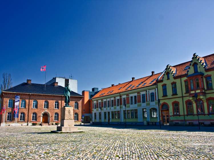 Kristiansand Town Square with   norwegian flag on top of  building.