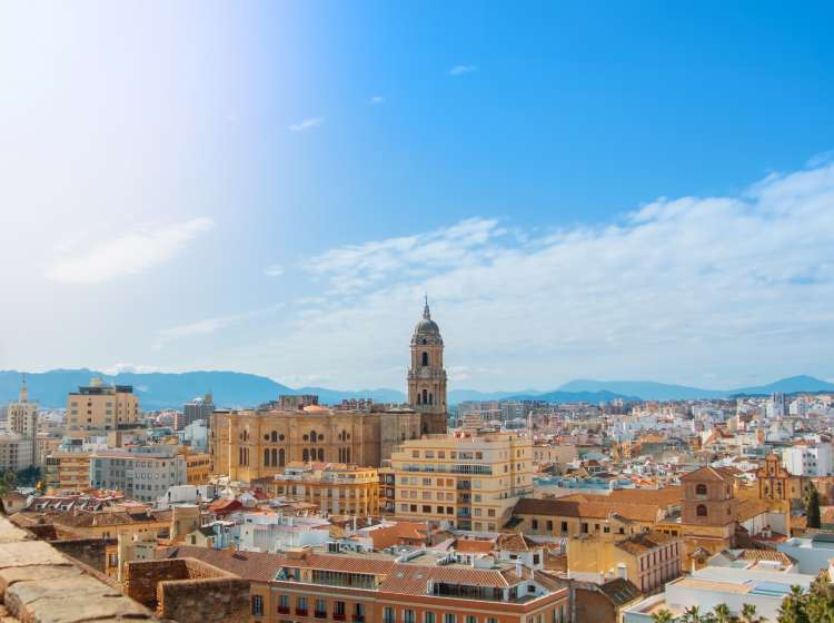 Aerial panoramic view over the roofs to a tower of Malaga Cathedral from the walls and towers of Castillo Gibralfaro (Castle of Gibralfaro) on sunny day, Andalusia, Spain.; Shutterstock ID 770819320; Invoice Number: -