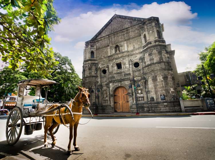 Horse Drawn Carriage parking in front of Malate church , Manila Philippines. The church is a Baroque-style church  was first built in 1588.