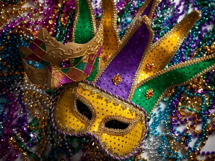 A group of mardi gras beads an mask with copy space