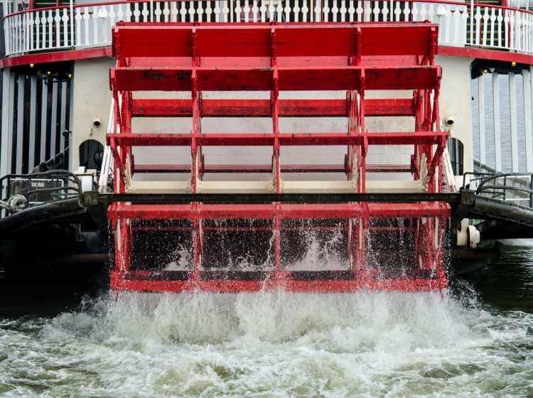 A red water wheel churns in the Mississippi River; Shutterstock ID 583863823; Invoice Number: -