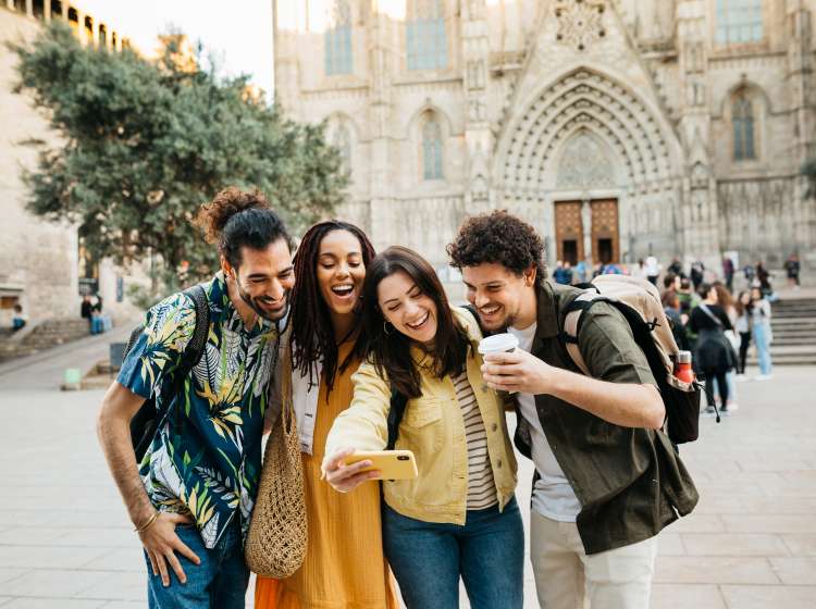 Small group of multiracial young tourists taking a selfie in front of the Barcelona's cathedral. Catalonia. Spain