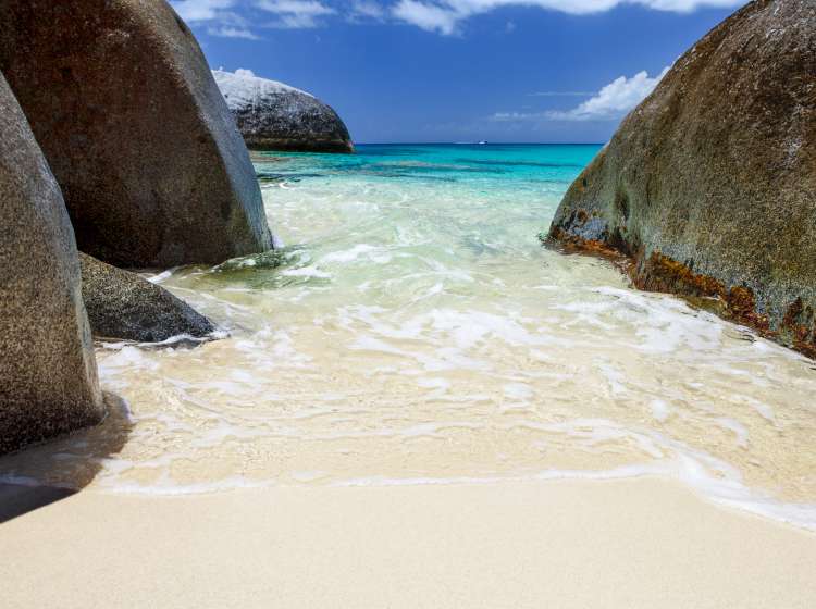 unspoiled beach with volcanic boulders at Spring Bay in Virgin Gorda, British Virgin Islands