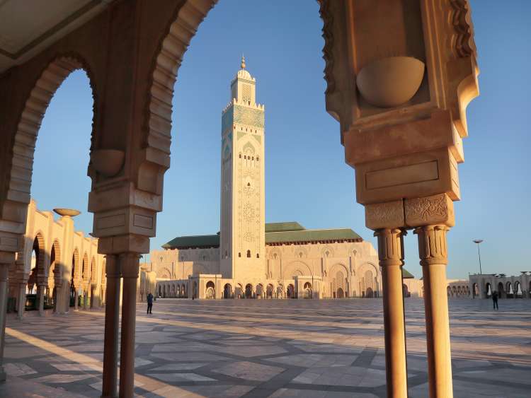 Beautiful Arch frame of islamic Minaret of the Hassan II Mosque in Casablanca Morocco against blue sky