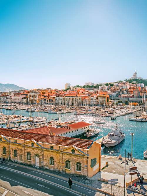 Harbour being overlooked by buildings and mountains