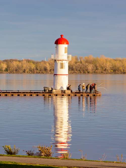 Lighthouse on a small pier in the sea in Sept Isles