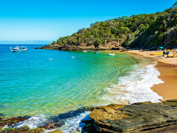 Paradise beach with colorful transparent waters surrounded by stones and vegetation in the city of Buzios, one of the main tourist destinations in Rio de Janeiro