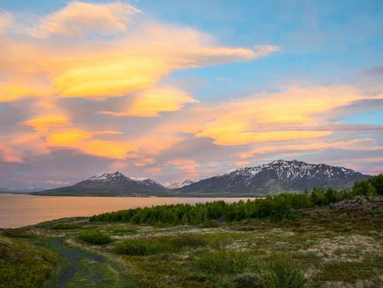 The sunset is reflected in the clouds near island of Hrisey in Iceland; Shutterstock ID 1136443367; Project: Adobe