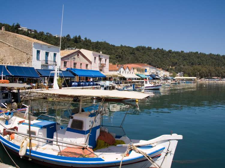 Small Fishing Boat and view of Restaurant Row on the Harbor at Katakolon Greece