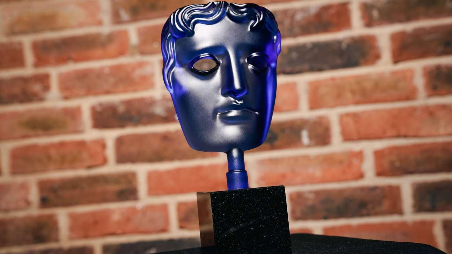 P&O Cruises Bafta trophy against brick wall background