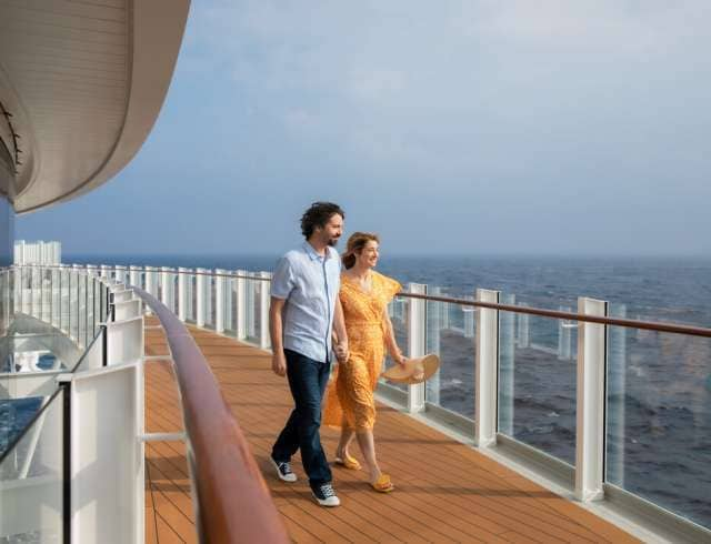 Couple going for a walk on the promenade deck on board Iona