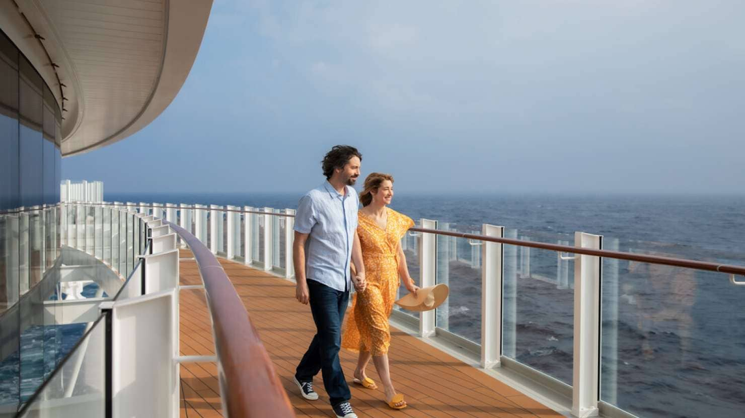 Couple going for a walk on the promenade deck on board Iona