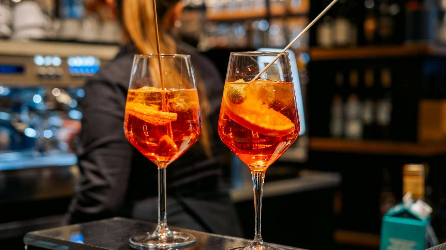 traditional Italian cocktail Spritz with ice and olives, an aperitif in Rome, Milan Venice Florence