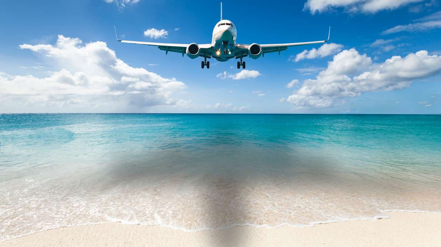 Aircraft landing at Princess Juliana International Airport in Netherlands Antilles.