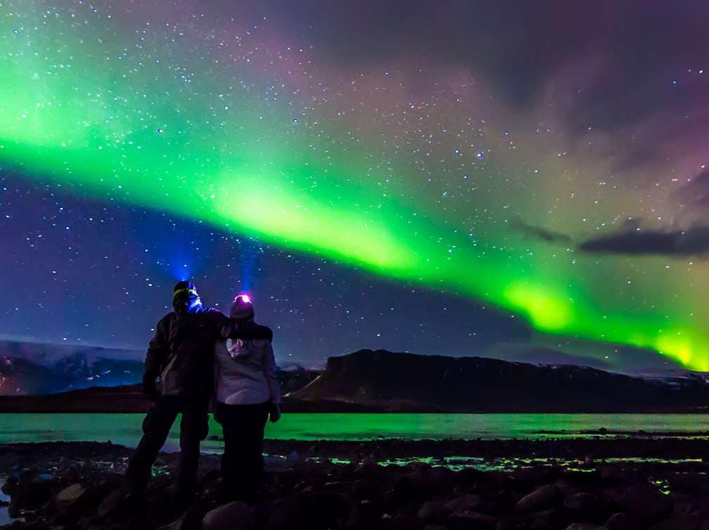 A couple observing the Northern Lights