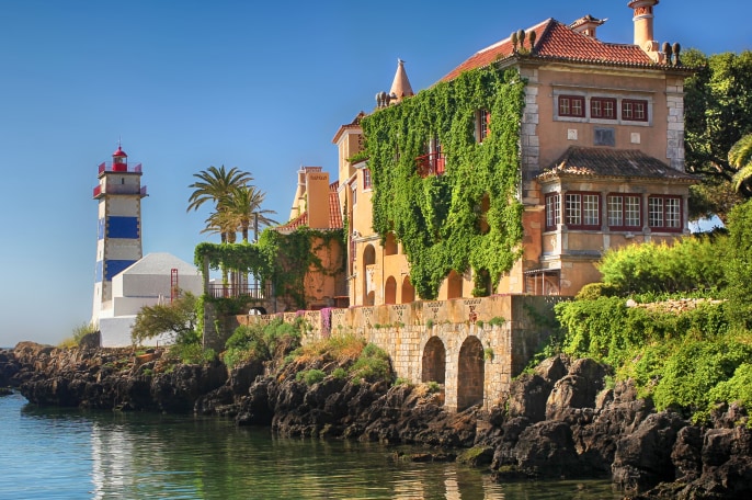  A building and lighthouse by water