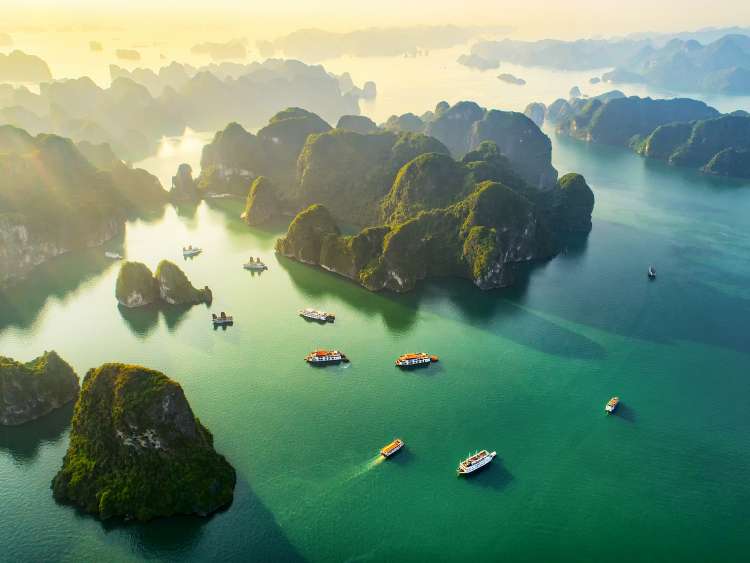 Aerial view floating fishing village and rock island, Halong Bay, Vietnam, Southeast Asia. UNESCO World Heritage Site. Junk boat cruise to Ha Long Bay. Popular landmark, famous destination of Vietnam
; Shutterstock ID 1218765286; project: olly; job: ; client: pocruises; other: 