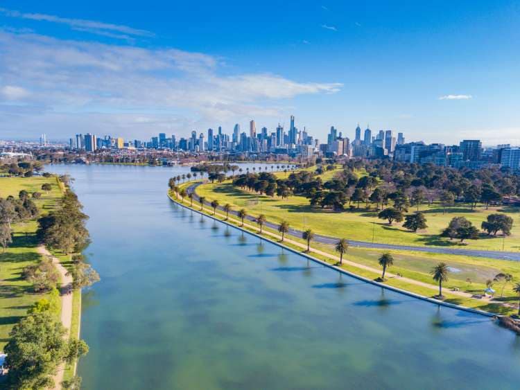 Drone shot of Albert Park Lake, Victoria, Australia with Melbourne City skyline in the background