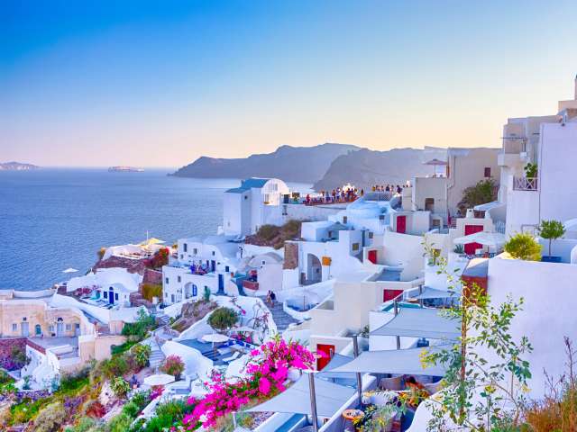 View over Santorini's whitewashed and limewashed houses next to the Agean Sea