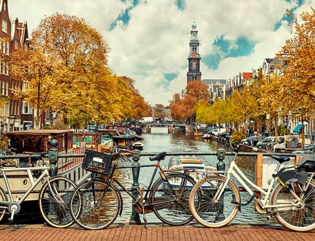 Bikes tied up on Torensluis bridge over the canal in Amsterdam