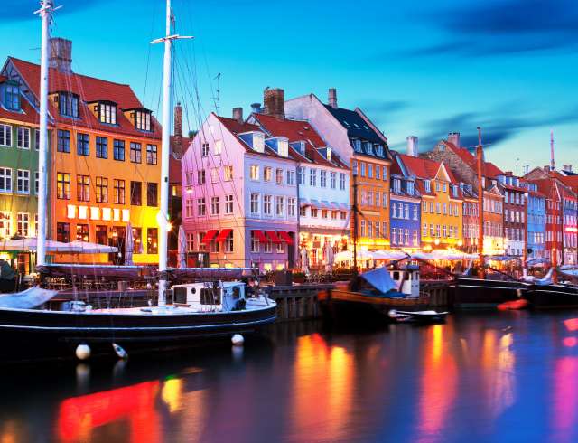 Boats moored alongside Nyhavn Quayside in Copenhagen, Denmark