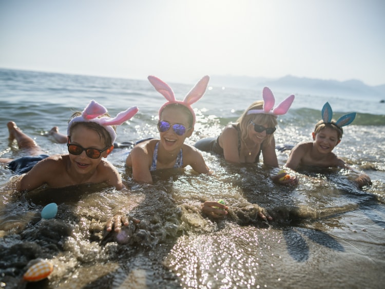 Family on a beach wearing easter bunny ears