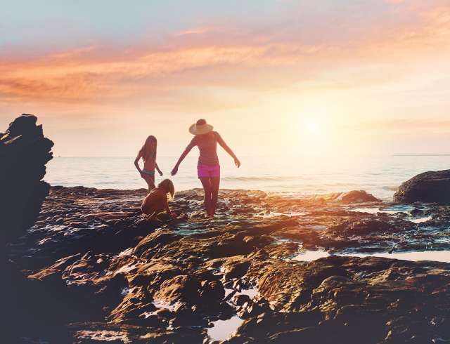 Mother and children enjoying rock-pools in Gran Canaria