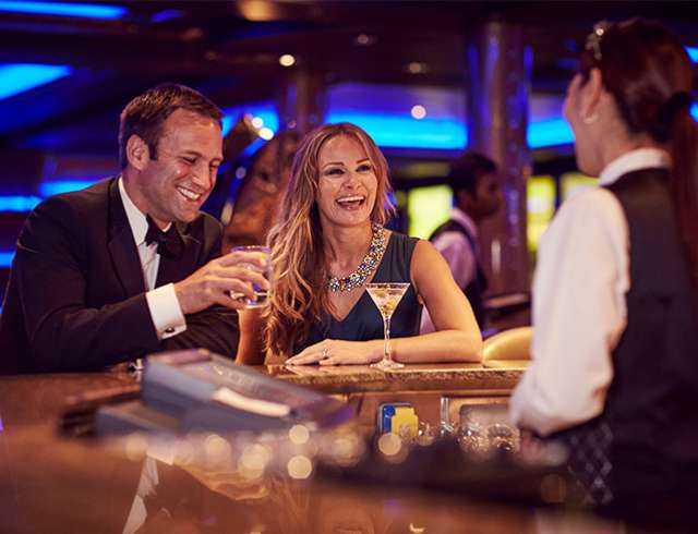 Couple enjoying drinks at bar during celebration night