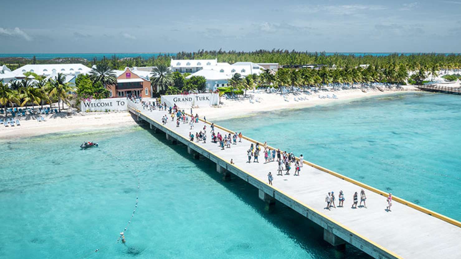 People walking down the Grand Turk pier