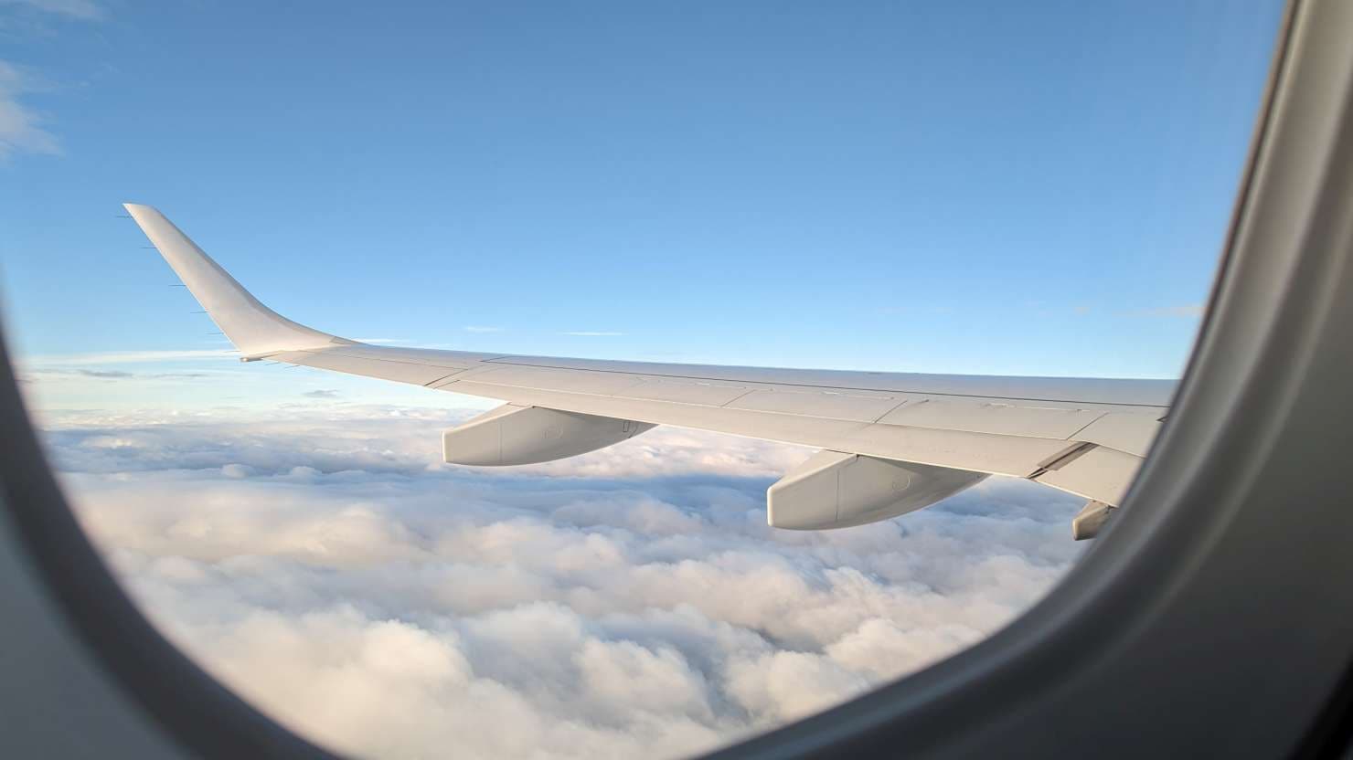 Close up of jet wing in sky