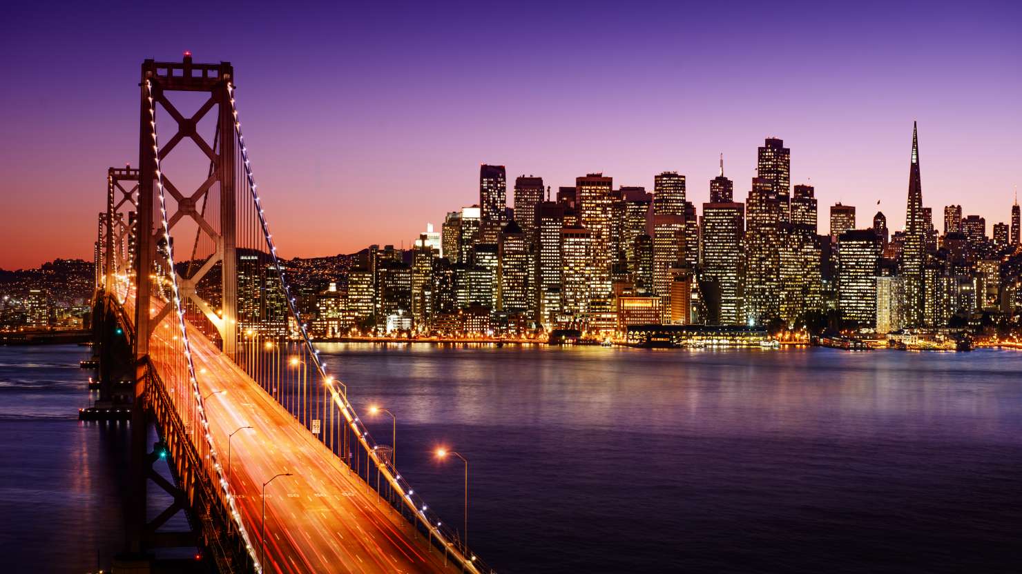 San Francisco skyline and Bay Bridge at sunset, California