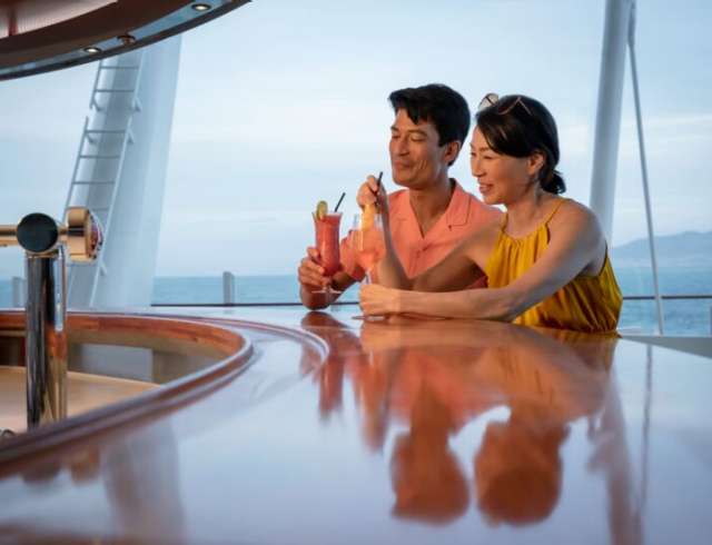 Couple enjoying cocktails at a bar on P&O Cruises ship Iona