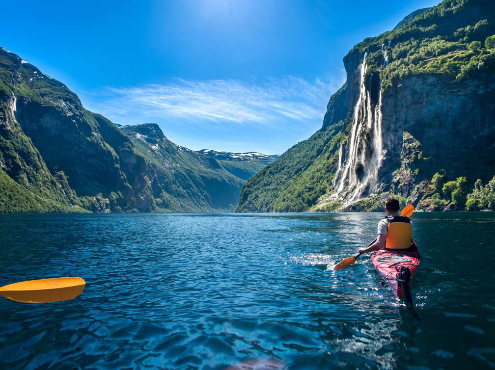 Man in Kayak over lake in Norwegian Fjords