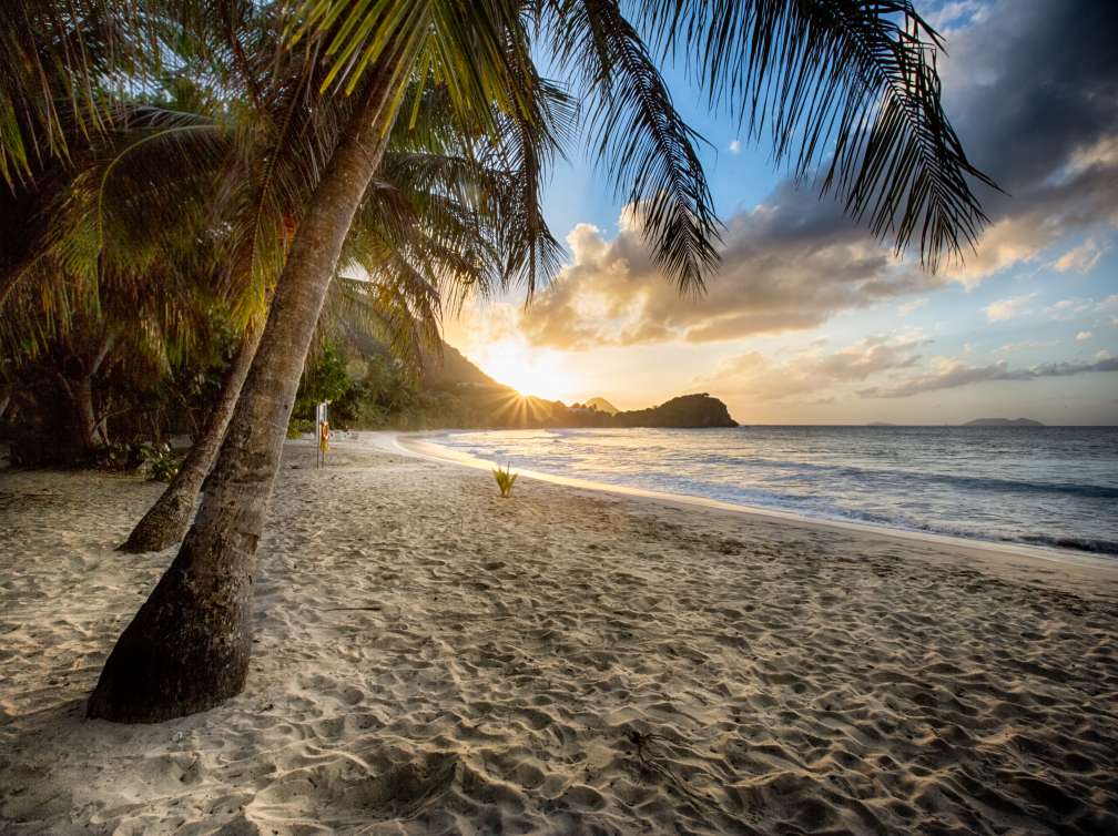 Placid beach at sunset on a tropical beach on a volcanic island in the Caribbean