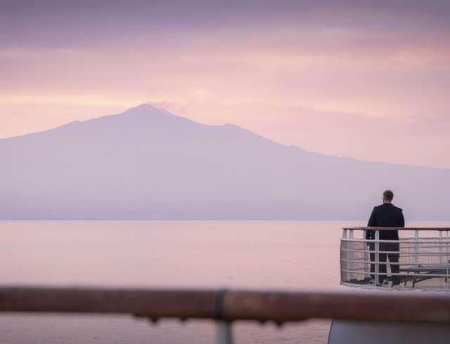 Mount Etna seen during a sunset sailaway from Catania, Sicily in Italy during press trip A422B on board Azura. 
Client: P&O Cruises.
Picture date: Tuesday August 27, 2024.
Photograph by Christopher Ison ©
07544044177
chris@christopherison.com
www.christopherison.com
IMPORTANT NOTE REGARDING IMAGE LICENCING FOR THIS PHOTOGRAPH: This image is supplied to the client under the terms previously agree. No sales are permitted unless expressly agreed in writing by the photographer. Image licence is for below the line only. No out of home use without acquiring an extended image licence.