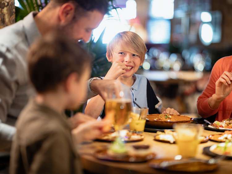 A family having a meal together in a restaurant.; Shutterstock ID 1625110438; project: po; job: po; client: po; other: 