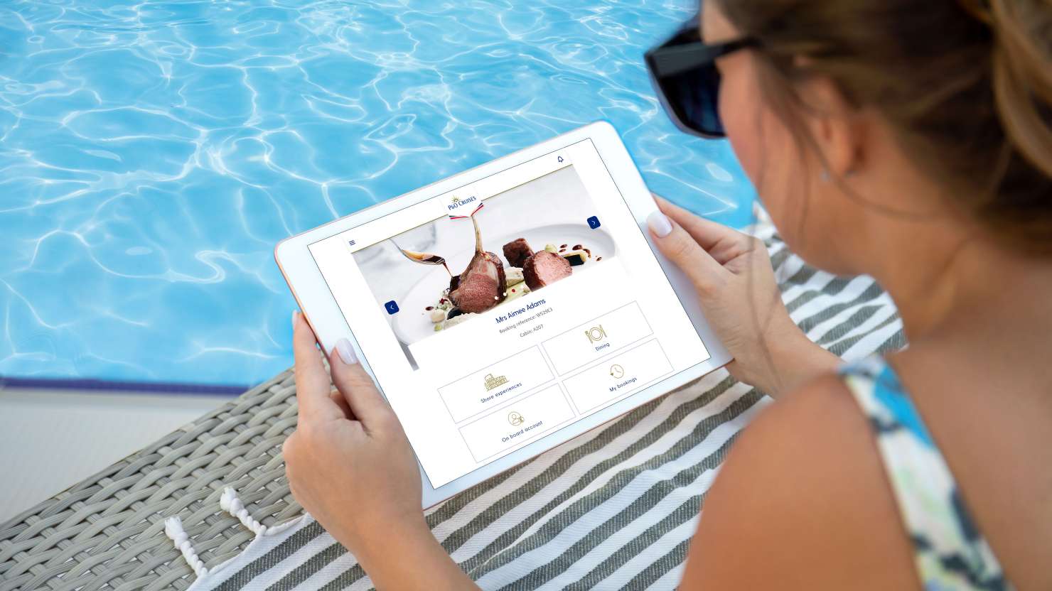 woman in hands holds computer tablet with isolated screen near the pool